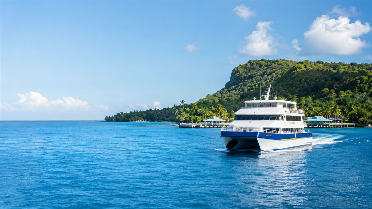 Ferry departing an island jetty at sunrise
